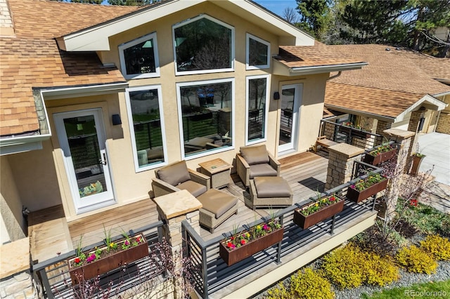 back of property with an outdoor living space, roof with shingles, and stucco siding