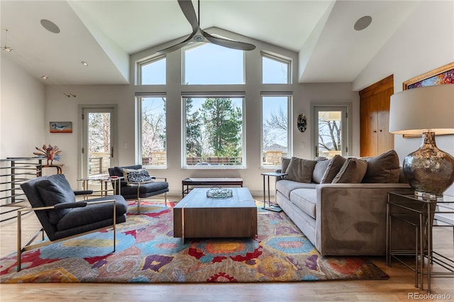 living area with vaulted ceiling, wood finished floors, and ceiling fan