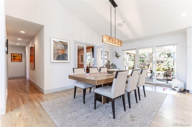 dining room featuring high vaulted ceiling, baseboards, recessed lighting, and light wood-style flooring