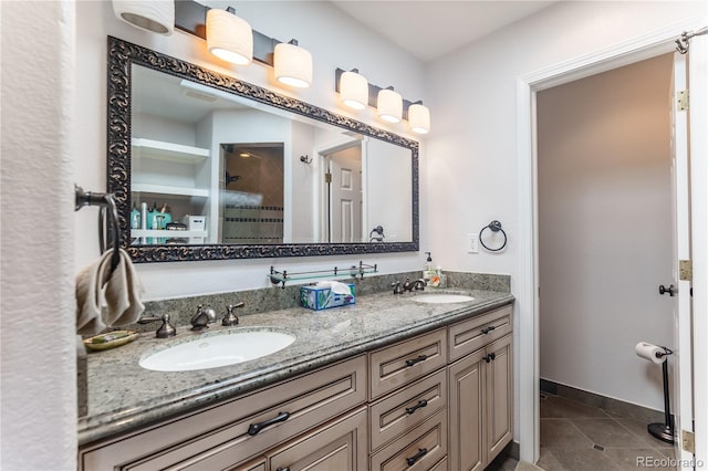 full bath featuring tile patterned floors, walk in shower, a sink, and double vanity