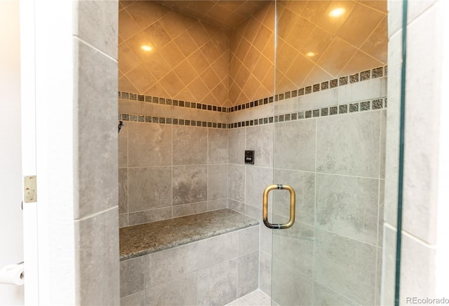 full bathroom with recessed lighting and a shower stall