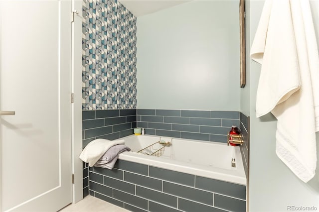 bathroom featuring a bath and wallpapered walls