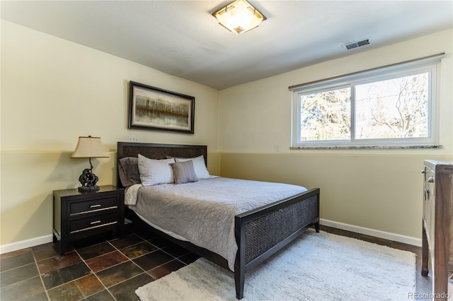 bedroom with visible vents and baseboards