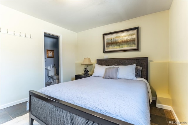 bedroom with baseboards and ensuite bathroom