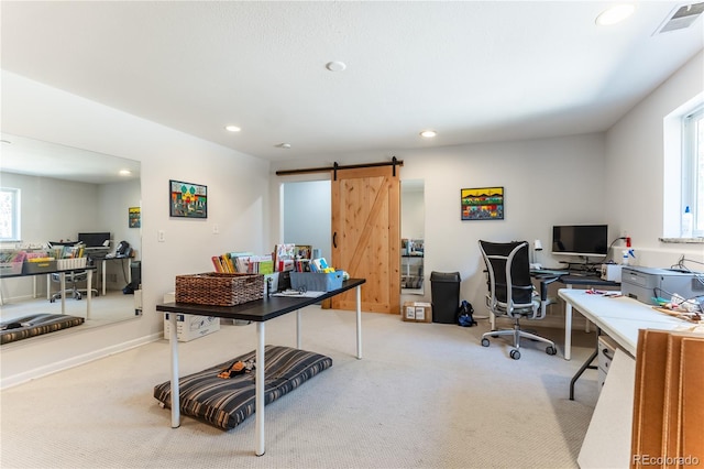 office space featuring a barn door, carpet floors, baseboards, visible vents, and recessed lighting