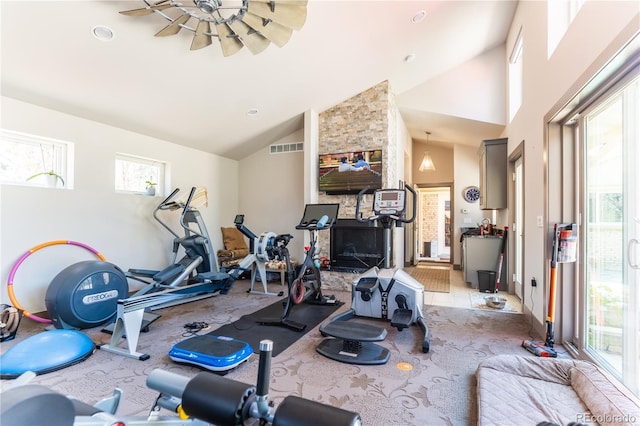 workout area with carpet floors, visible vents, and high vaulted ceiling