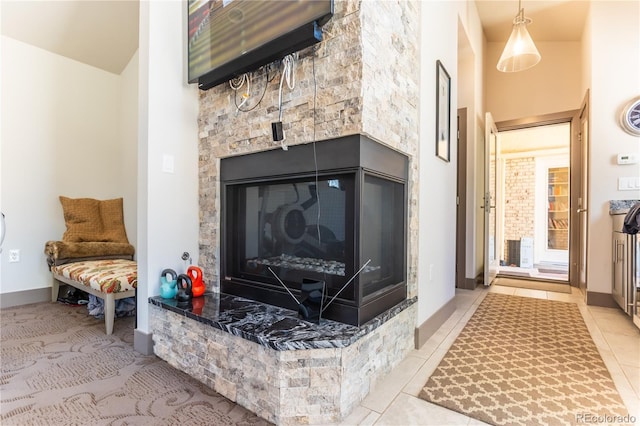 interior details with baseboards and a glass covered fireplace