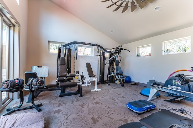 exercise room with high vaulted ceiling, baseboards, and carpet flooring
