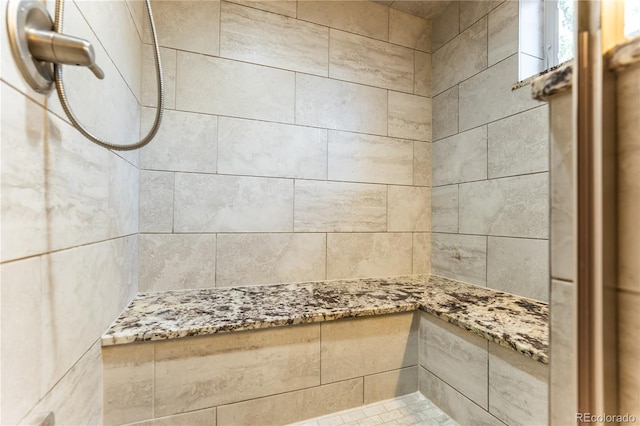 full bath with tiled shower