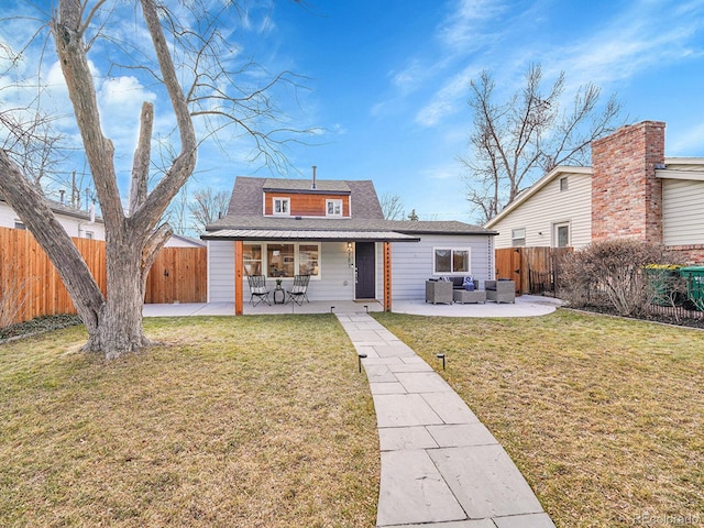 back of house with a fenced backyard, a lawn, and an outdoor living space