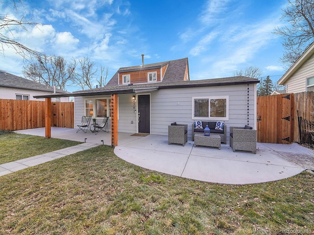 rear view of property featuring fence, outdoor lounge area, a lawn, and a patio