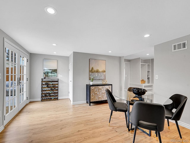 dining room featuring light wood finished floors, recessed lighting, visible vents, and french doors