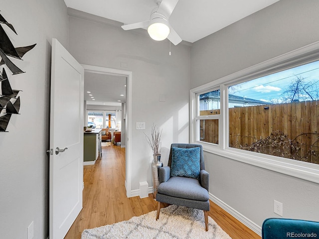 sitting room featuring light wood finished floors and baseboards