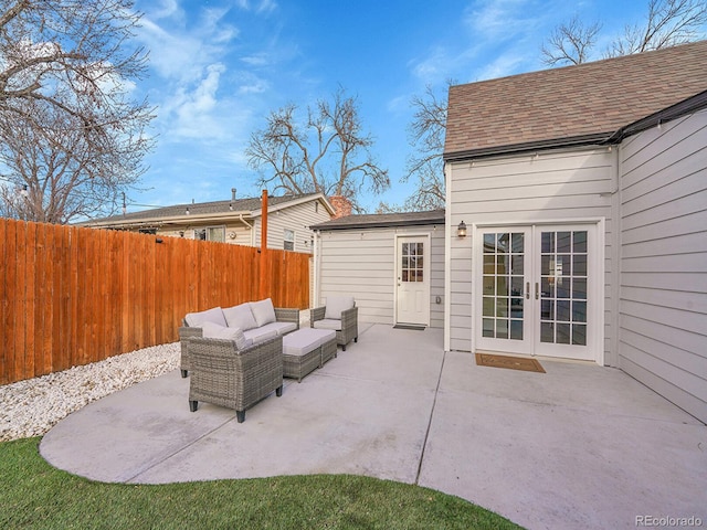 view of patio featuring french doors, outdoor lounge area, and fence