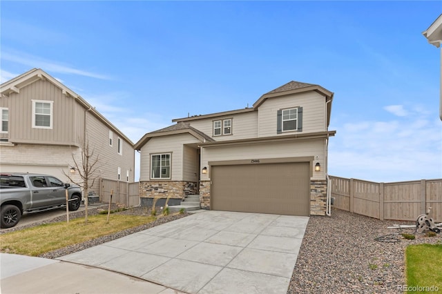 13446 Amber Sky St, Parker, CO 80134 - view of front of house featuring fence, driveway, an attached garage, and stone siding