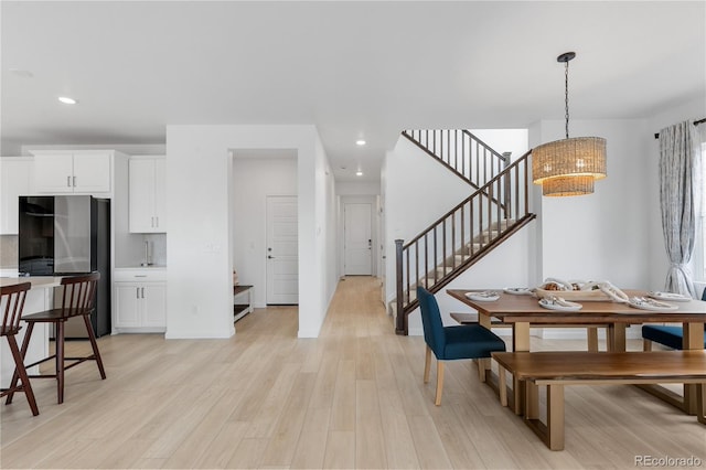 13446 Amber Sky St, Parker, CO 80134 - dining area featuring a chandelier, stairs, light wood finished floors, and recessed lighting