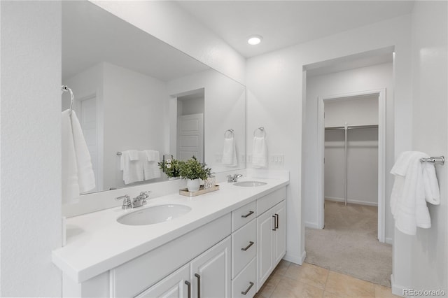 13446 Amber Sky St, Parker, CO 80134 - bathroom featuring double vanity, a walk in closet, and tile patterned floors