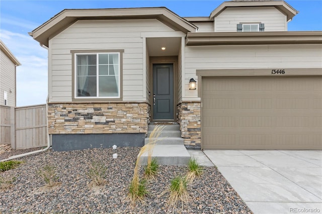 13446 Amber Sky St, Parker, CO 80134 - craftsman-style home with stone siding, an attached garage, concrete driveway, and fence