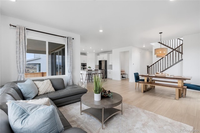13446 Amber Sky St, Parker, CO 80134 - living room with stairs, light wood-style flooring, and recessed lighting
