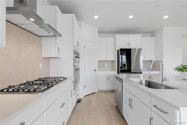 13446 Amber Sky St, Parker, CO 80134 - kitchen featuring wall chimney exhaust hood, a sink, appliances with stainless steel finishes, backsplash, and recessed lighting
