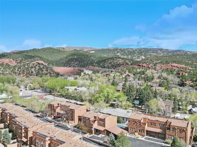 aerial view of property and surrounding area with a mountainous background and nearby suburban area