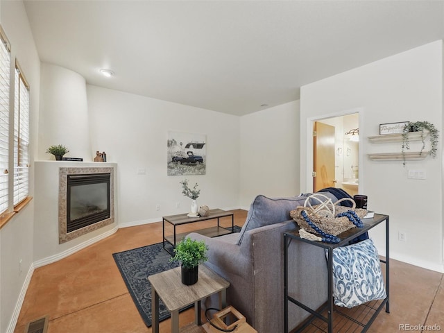 living area featuring a fireplace and baseboards