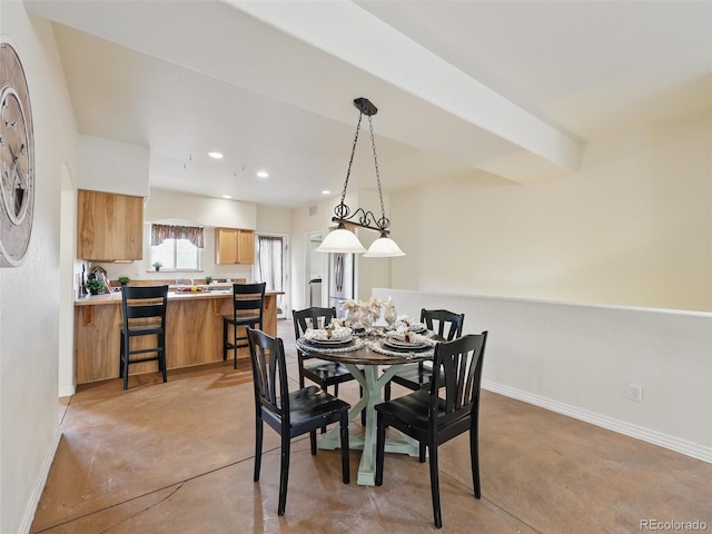 dining room featuring baseboards, finished concrete flooring, and recessed lighting