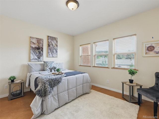 bedroom with multiple windows and baseboards