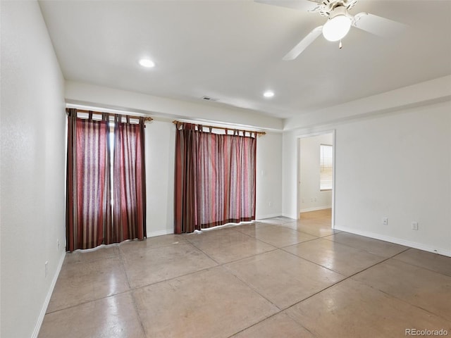 empty room with baseboards, finished concrete flooring, recessed lighting, and ceiling fan