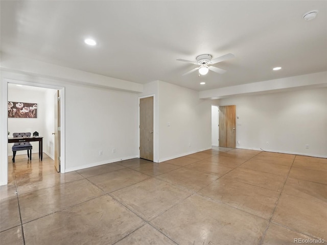 spare room with ceiling fan, recessed lighting, baseboards, and concrete flooring