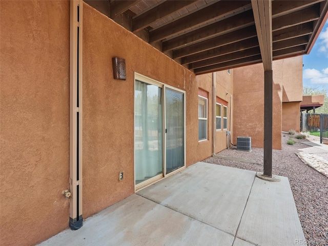 view of patio with fence and central AC unit