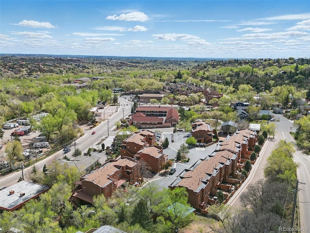 aerial view of property and surrounding area featuring nearby suburban area