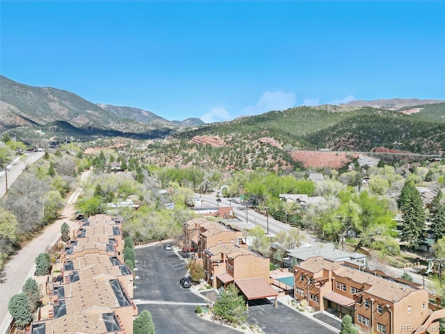 aerial view of property and surrounding area featuring mountains and nearby suburban area