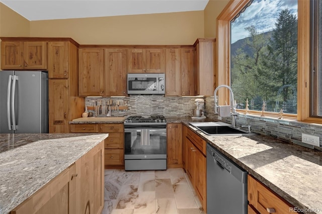 103 Trout Run Dr, Carbondale, CO 81623 - kitchen featuring appliances with stainless steel finishes, decorative backsplash, light marble finish flooring, and light stone countertops