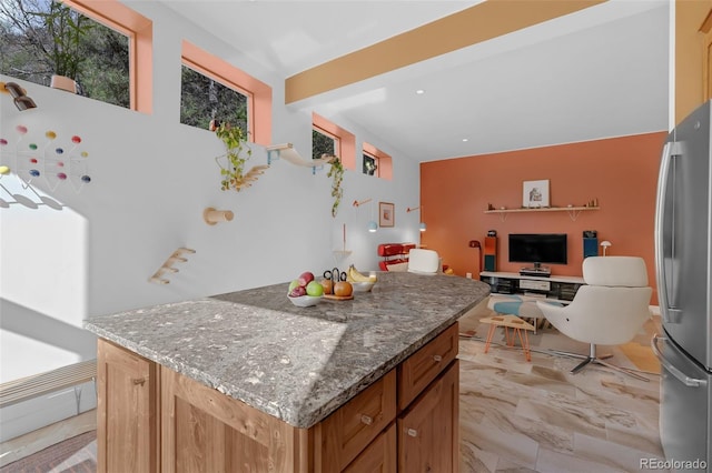 103 Trout Run Dr, Carbondale, CO 81623 - kitchen featuring freestanding refrigerator, a center island, stone countertops, open floor plan, and light marble finish floors