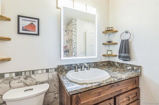 103 Trout Run Dr, Carbondale, CO 81623 - full bath with vanity, a shower, a wainscoted wall, and tile walls