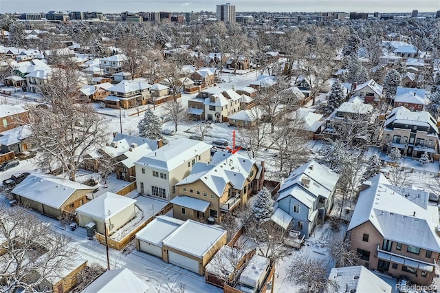 snowy aerial view with a residential view