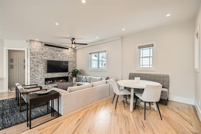 dining area with recessed lighting, a fireplace, wood finished floors, and baseboards