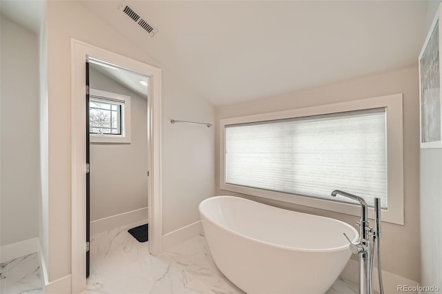 full bathroom with baseboards, visible vents, lofted ceiling, a soaking tub, and marble finish floor