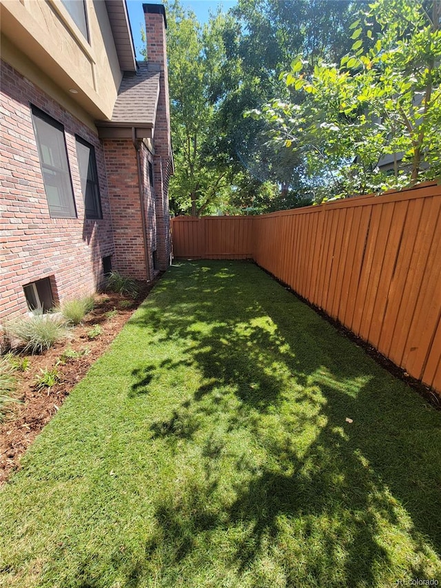 view of yard with a fenced backyard