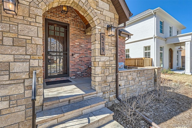 property entrance with brick siding