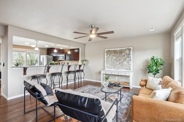 1095 W 69th Ave, Denver, CO 80221 - living area featuring dark wood-type flooring and ceiling fan
