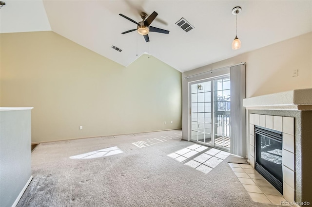 unfurnished living room featuring ceiling fan, lofted ceiling, light carpet, and a fireplace