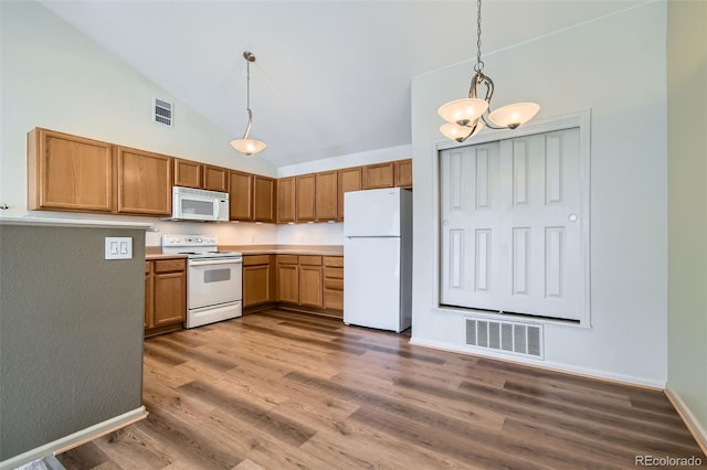 kitchen featuring high vaulted ceiling, dark hardwood / wood-style floors, white appliances, and decorative light fixtures