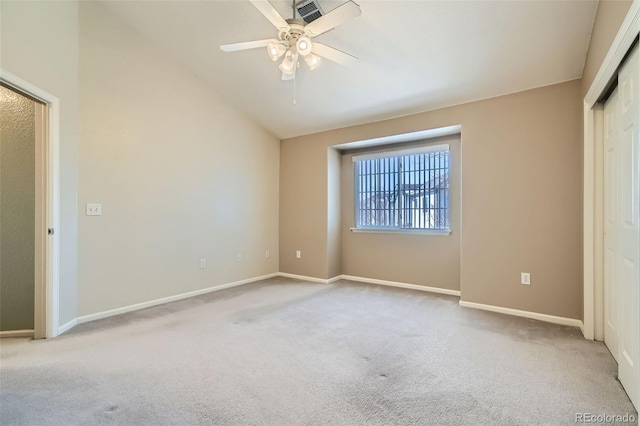 unfurnished bedroom with ceiling fan, lofted ceiling, and light carpet