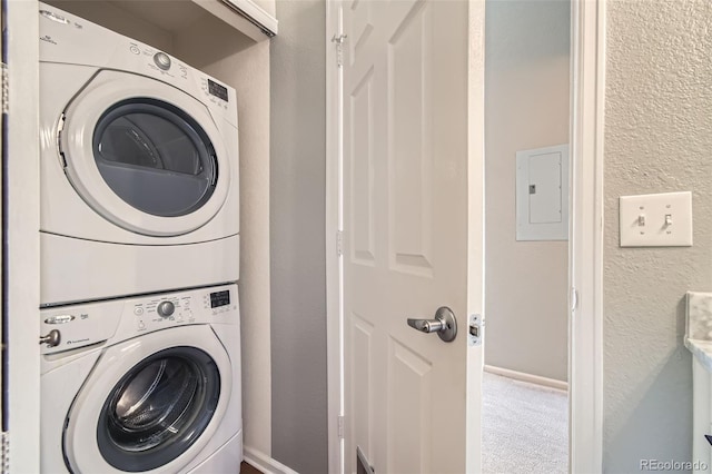 laundry room featuring stacked washer / dryer, carpet, and electric panel