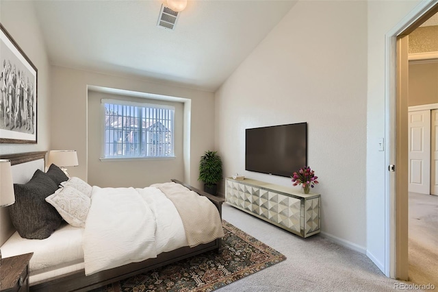 bedroom featuring vaulted ceiling, carpet, visible vents, and baseboards