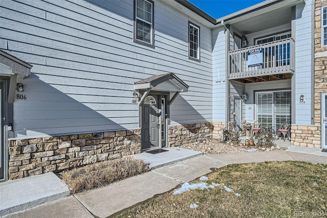 property entrance with stone siding