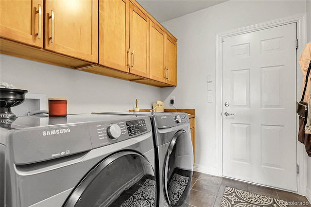 10152 Bluffmont Ln, Lone Tree, CO 80124 - washroom with cabinet space, washing machine and clothes dryer, and dark tile patterned floors