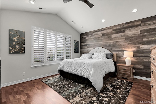 10152 Bluffmont Ln, Lone Tree, CO 80124 - bedroom with vaulted ceiling, an accent wall, wood walls, recessed lighting, and dark wood finished floors